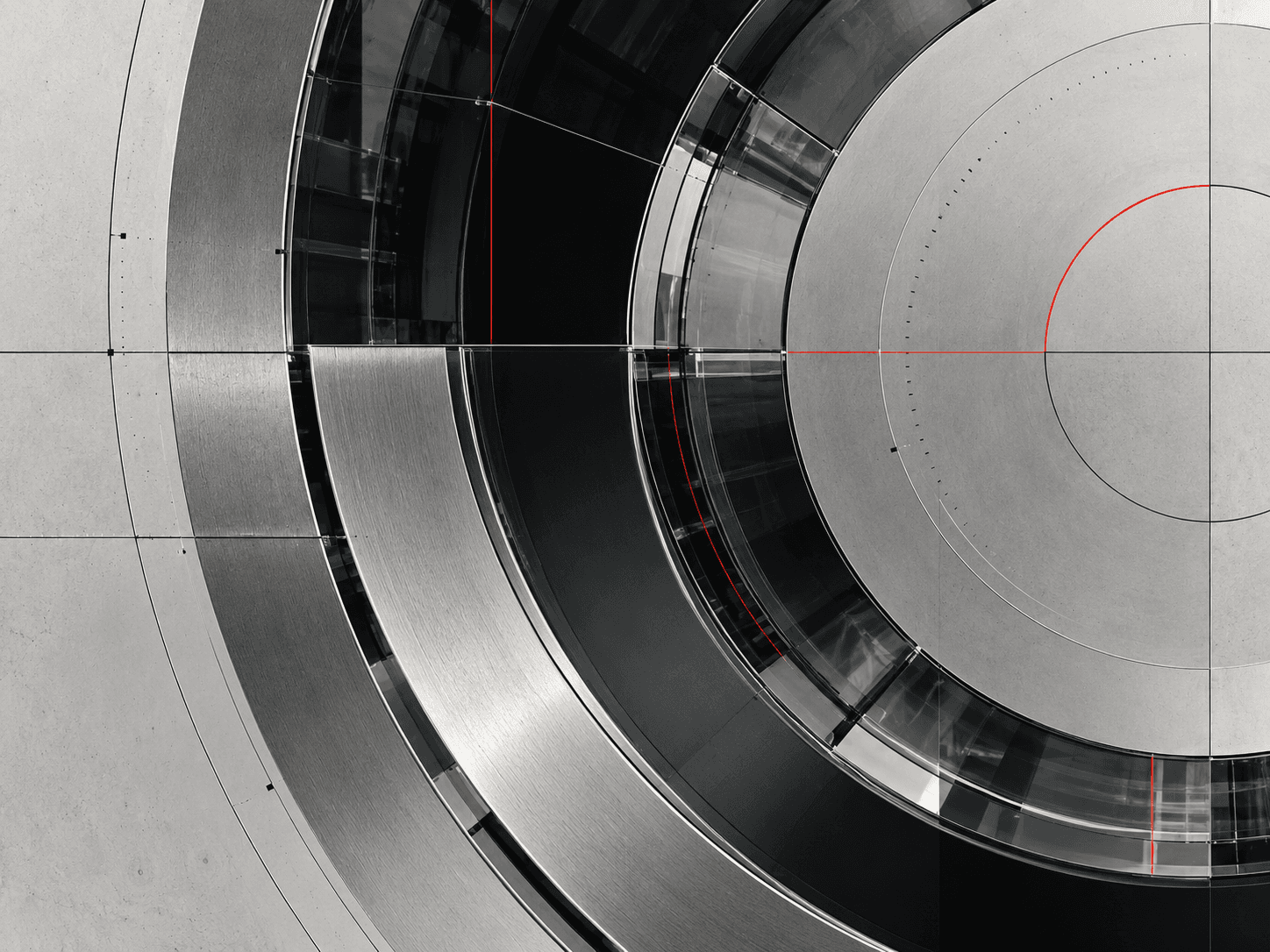 Machined aluminium rings with glass segments and fine construction lines.